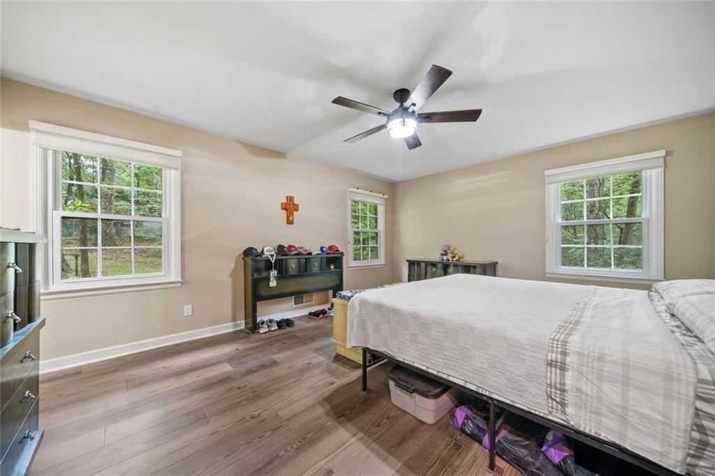286 Hilton Way Canton, GA 30114 - Photo 24 of 59 a bedroom with a bed dresser and a window