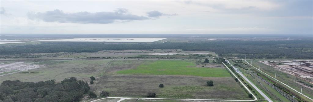 1455 South Duette Road Myakka City, FL 34251 - Photo 9 of 15 a view of a dry yard with wooden fence