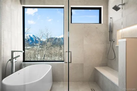 a bathroom with a bathtub and shower