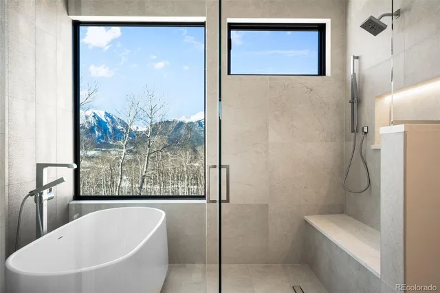 a bathroom with a bathtub and shower