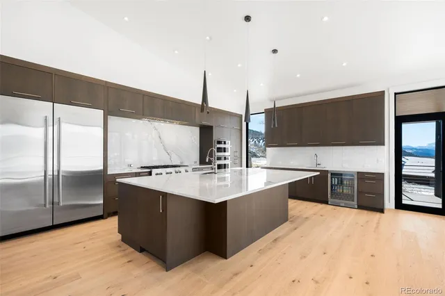 a kitchen with stainless steel appliances kitchen island a sink stove and refrigerator
