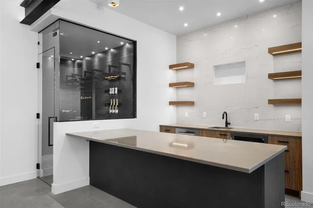 a kitchen with a sink a counter and cabinets