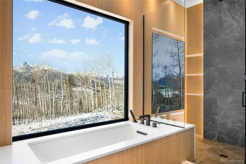 a bathroom with a bathtub and shower