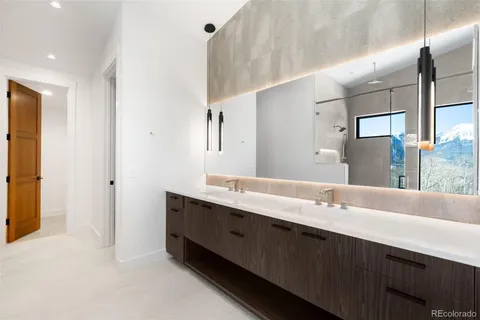 a bathroom with a double vanity sink mirror and double