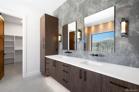 a bathroom with a double vanity sink and a mirror