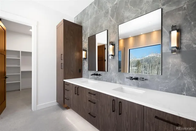 a bathroom with a double vanity sink and a mirror