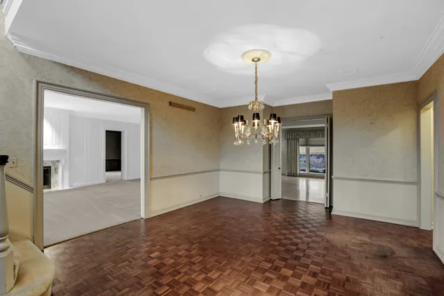 a view of an empty room with a fireplace and a window