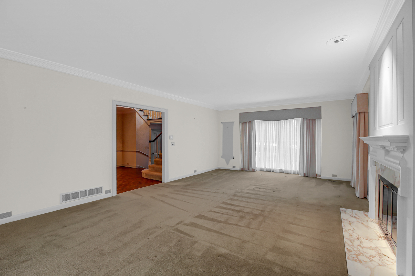 9S174 Drew Avenue Burr Ridge, IL 60527 - Photo 13 of 49 a view of an empty room with a fireplace and a window