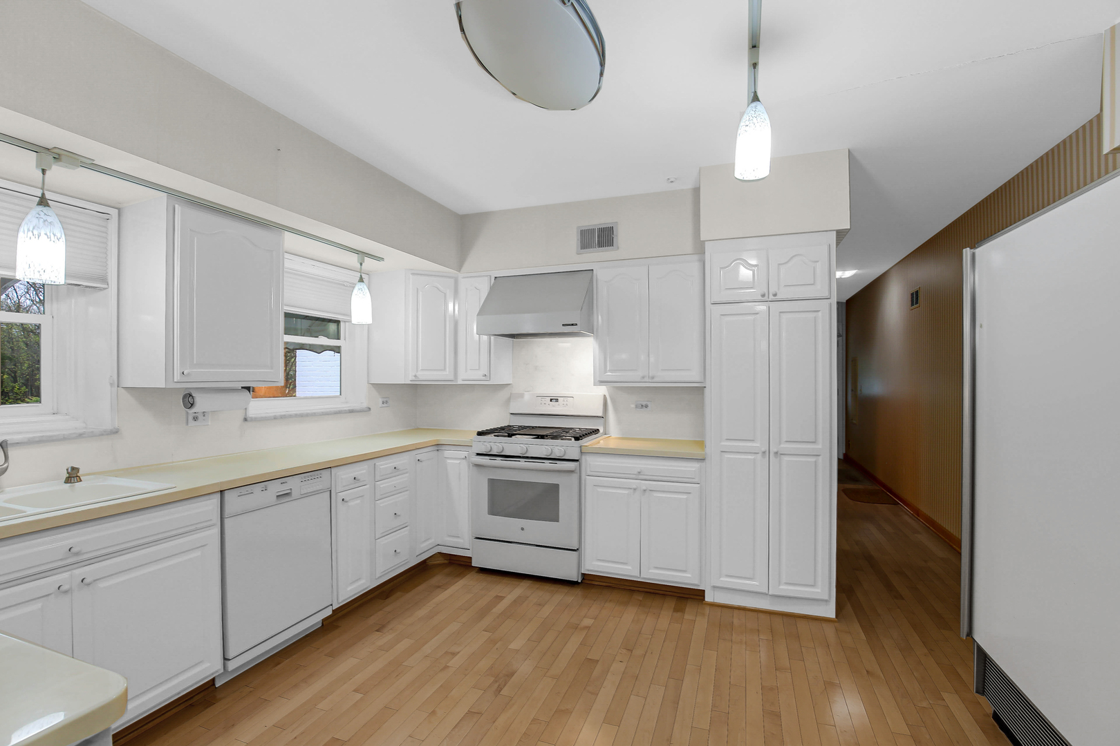 9S174 Drew Avenue Burr Ridge, IL 60527 - Photo 21 of 49 a kitchen with stainless steel appliances granite countertop a sink a stove a refrigerator and island with wooden floor