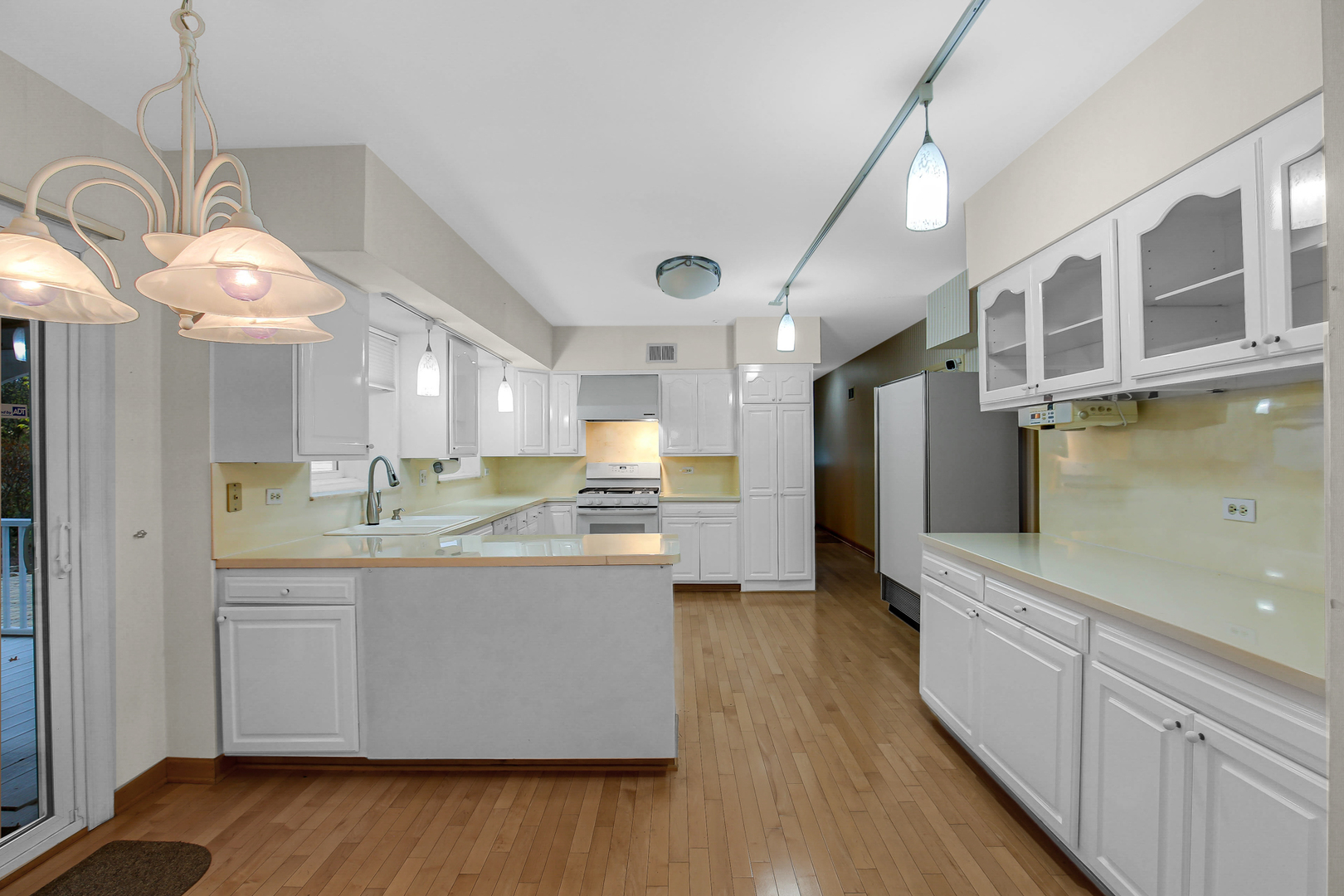 9S174 Drew Avenue Burr Ridge, IL 60527 - Photo 22 of 49 a large kitchen with kitchen island a large counter space a sink appliances and cabinets