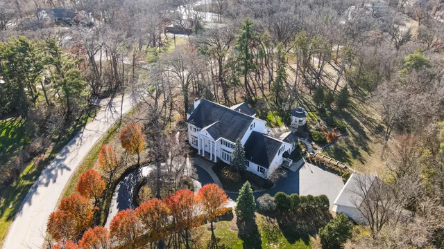 an aerial view of a house with a yard and garden