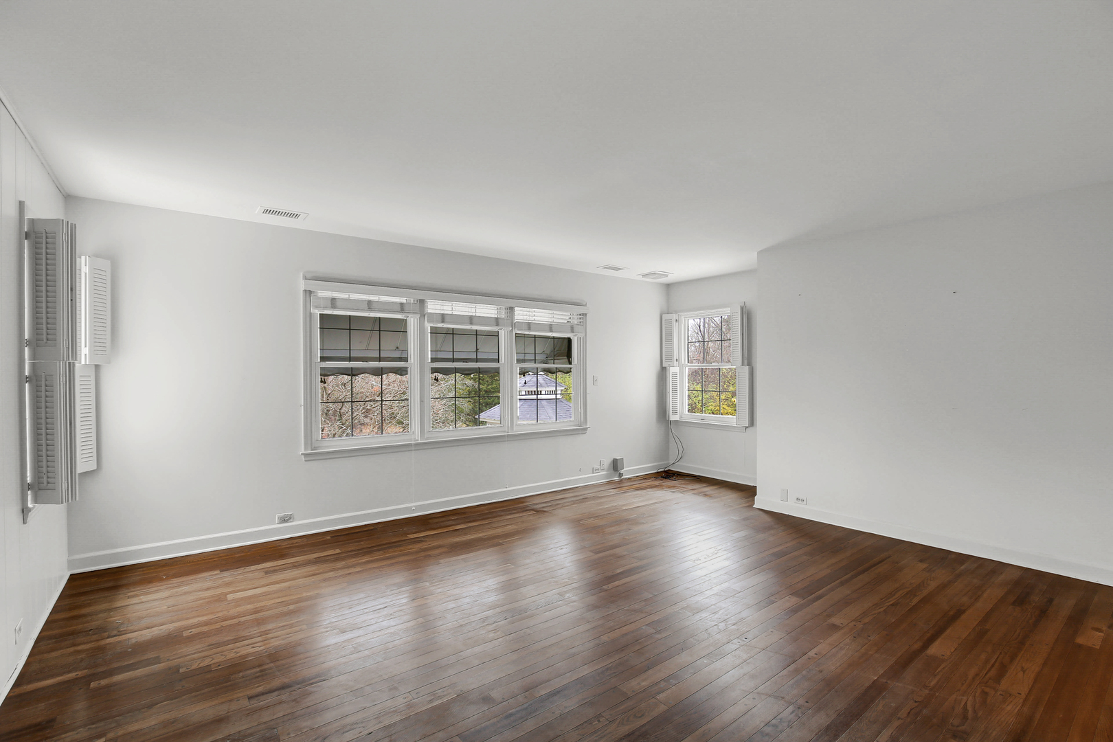 9S174 Drew Avenue Burr Ridge, IL 60527 - Photo 36 of 49 an empty room with wooden floor and windows