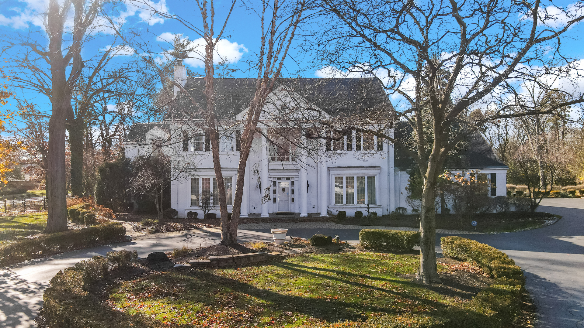 9S174 Drew Avenue Burr Ridge, IL 60527 - Photo 4 of 49 a view of a white house with a yard chairs and a fire pit