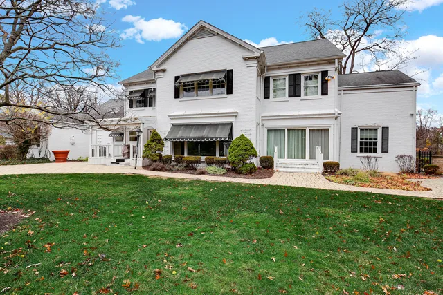 a view of house with yard and front view of a house