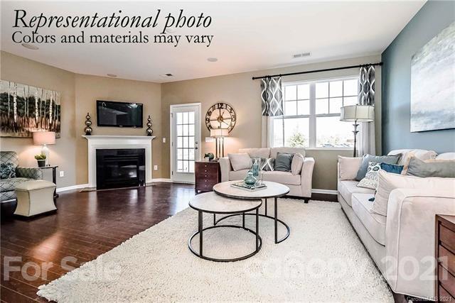 1663 Corwin Bend Road Tega Cay, SC 29708 - Photo 6 of 9 a living room with furniture a flat screen tv and a fireplace