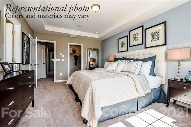 1663 Corwin Bend Road Tega Cay, SC 29708 - Photo 7 of 9 a spacious bedroom with a bed and a lamp