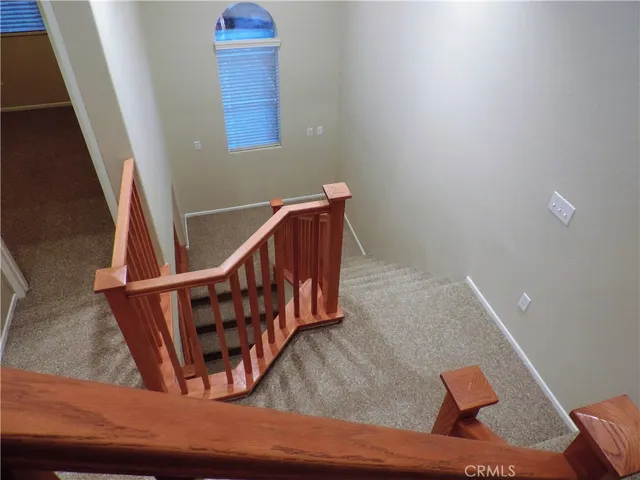 a view of staircase with white walls and stairs