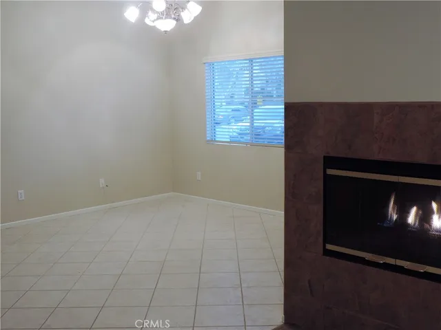 a view of an empty room with a fireplace