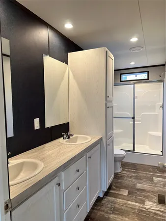 a bathroom with a double vanity sink and mirror