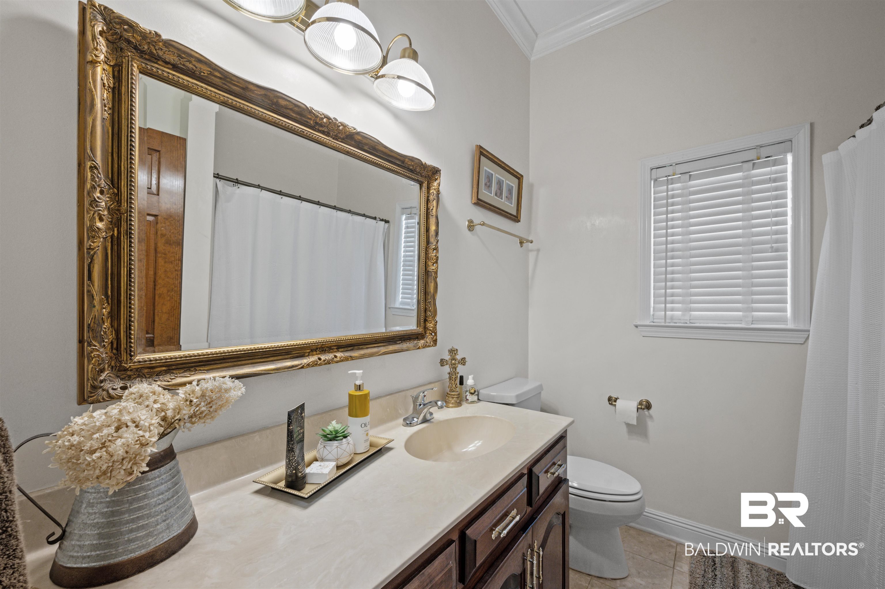 141 Blue Ridge Drive Monroeville, AL 36460 - Photo 20 of 40 Full bathroom featuring ornamental molding, vanity, tile patterned floors, and curtained shower