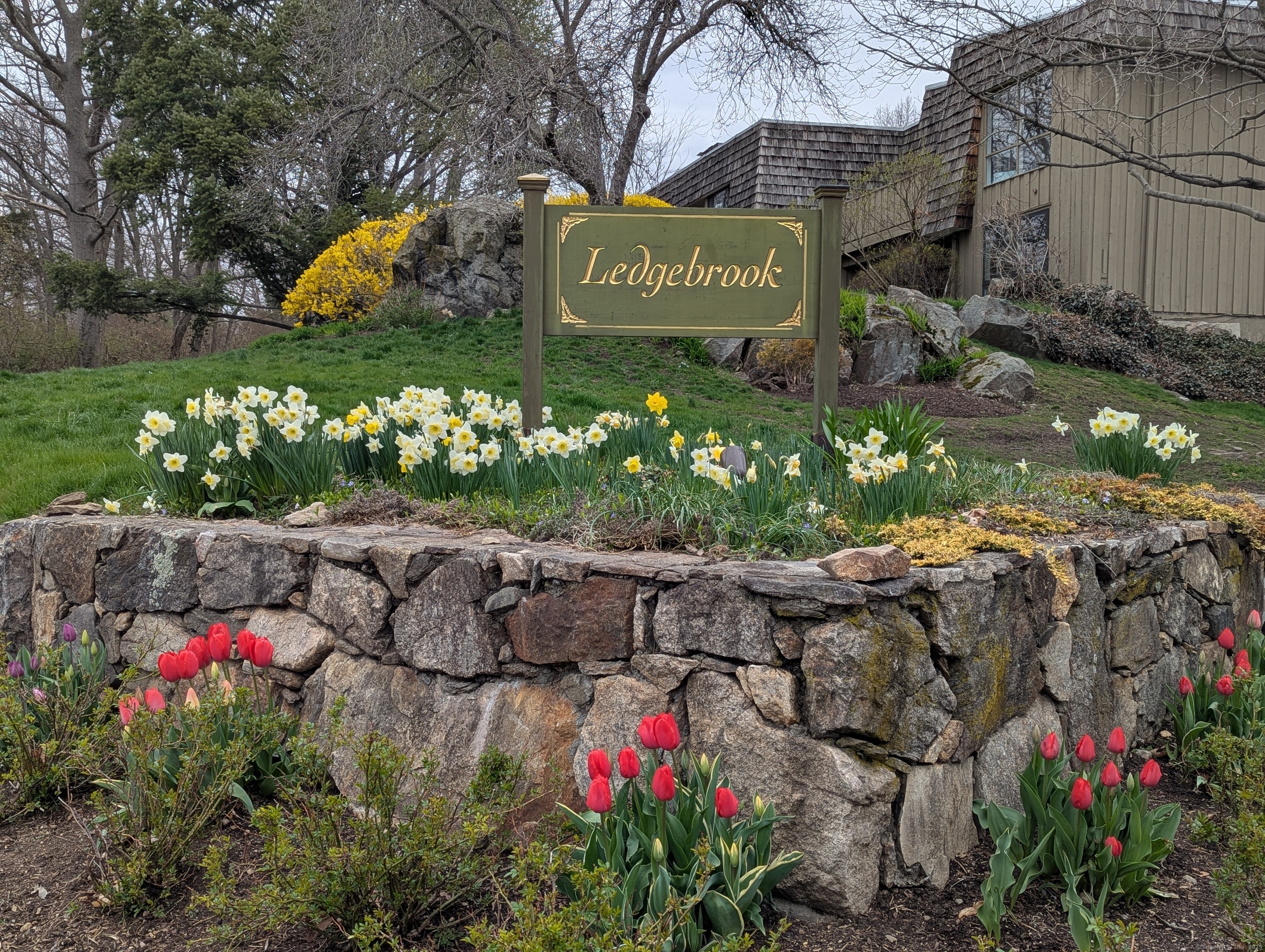 a sign that is in front of flowers