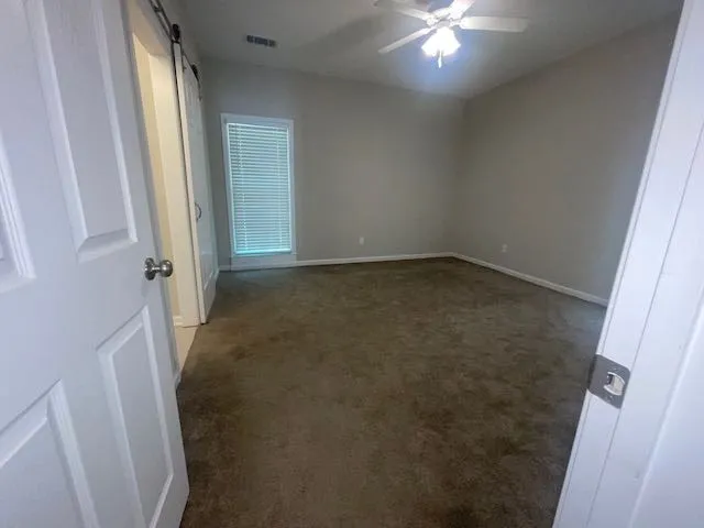 a view of an empty room with closet area