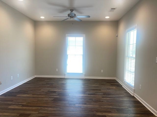 3612 4th Avenue Columbus, GA 31904 - Photo 2 of 19 an empty room with wooden floor fan and windows