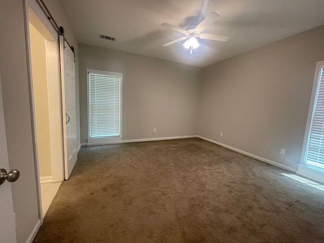 3612 4th Avenue Columbus, GA 31904 - Photo 7 of 19 an empty room with a ceiling fan and window