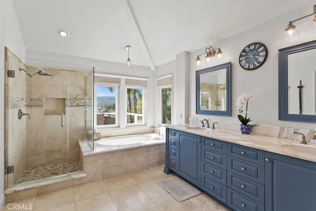 a spacious bathroom with a double vanity sink mirror and shower