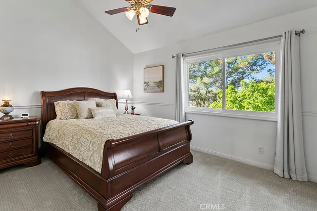 a bed sitting in a bedroom next to a window