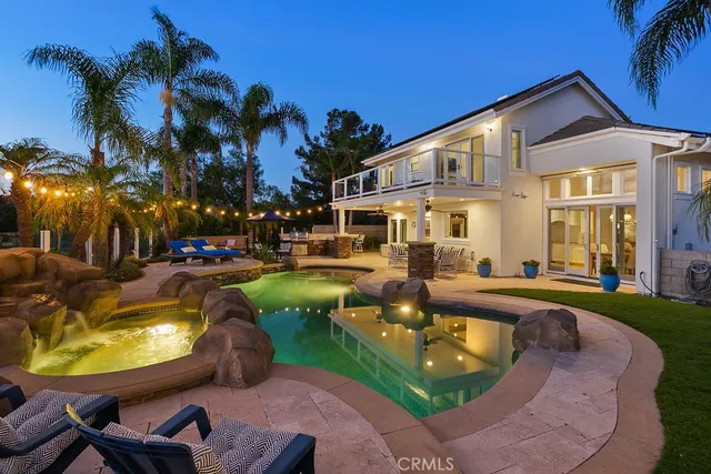 a view of a house with swimming pool and sitting area
