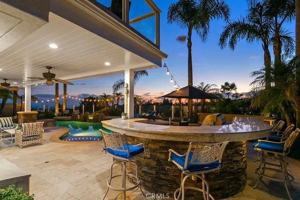 a view of a dining table and chairs in patio