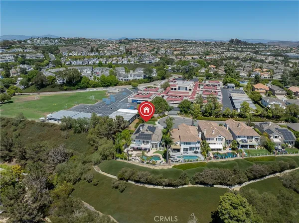 an aerial view of residential houses with outdoor space and lake view