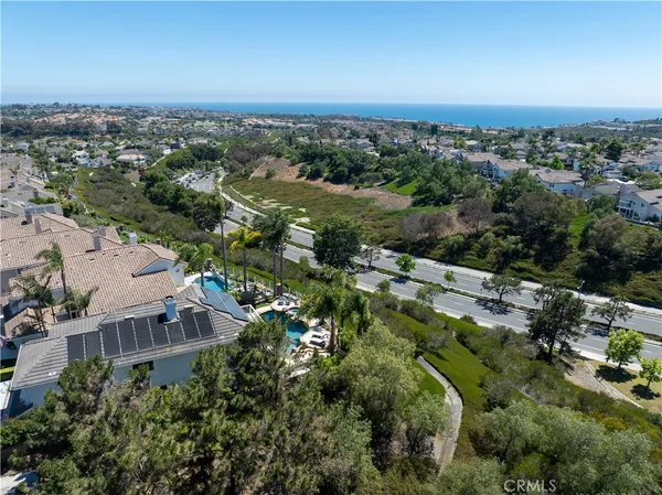 an aerial view of a house with a yard