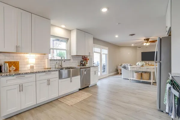 a kitchen with white cabinets and white appliances