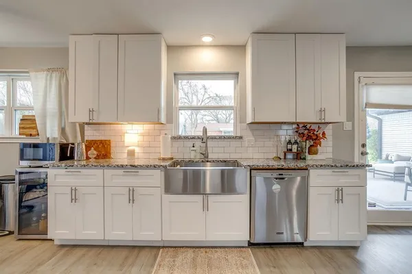a kitchen with stainless steel appliances granite countertop a sink and cabinets