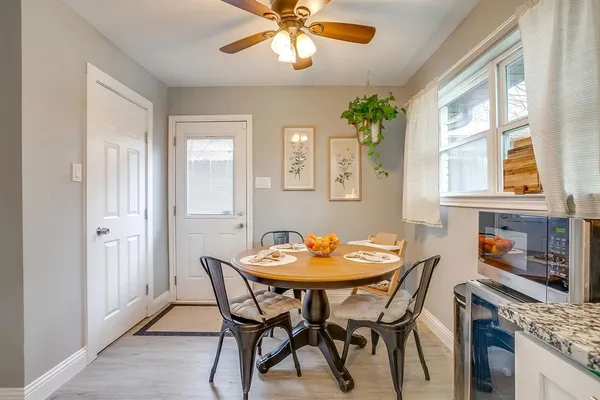 a dining room with furniture a chandelier and a window
