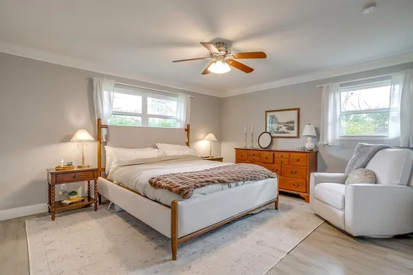 a bedroom with a bed couch and window