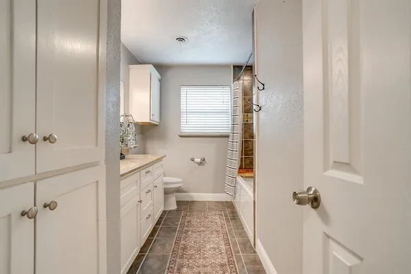 a bathroom with a double vanity sink toilet and shower