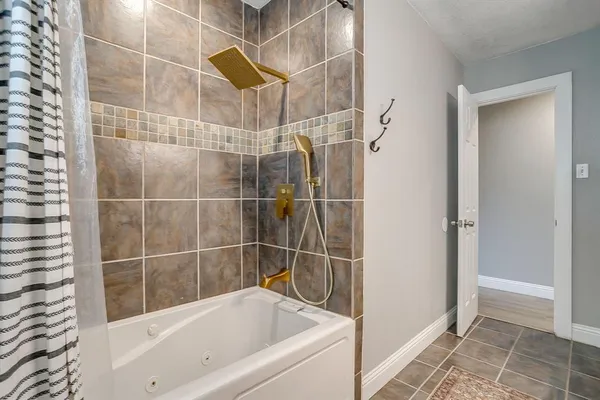 a bathroom with a bathtub and a shower