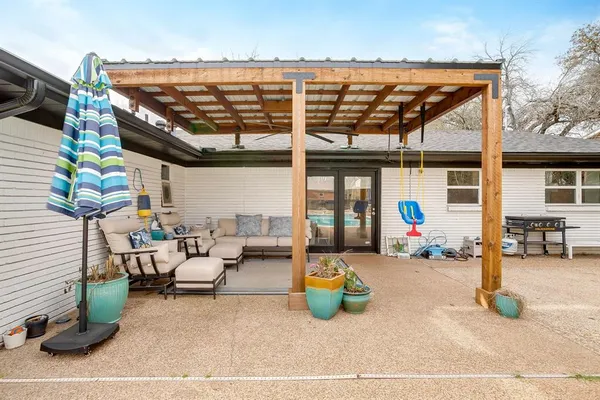 a view of a patio with a table and chairs and potted plants
