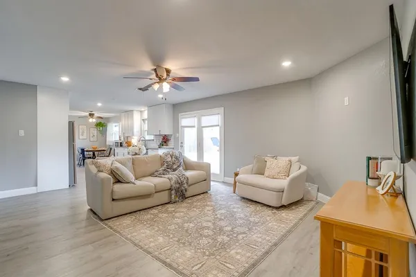 a living room with furniture and a chandelier