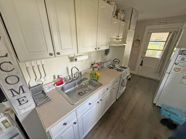 a kitchen with a sink stove and cabinets