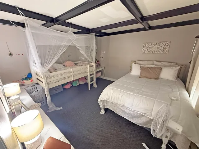 a bedroom with a bed and a mirror