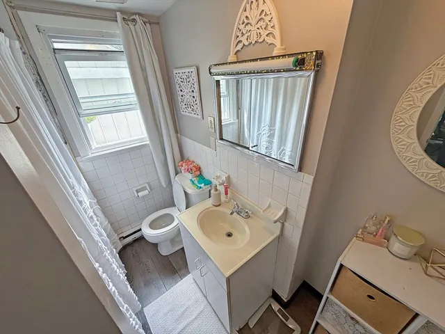 a bathroom with a sink toilet and mirror