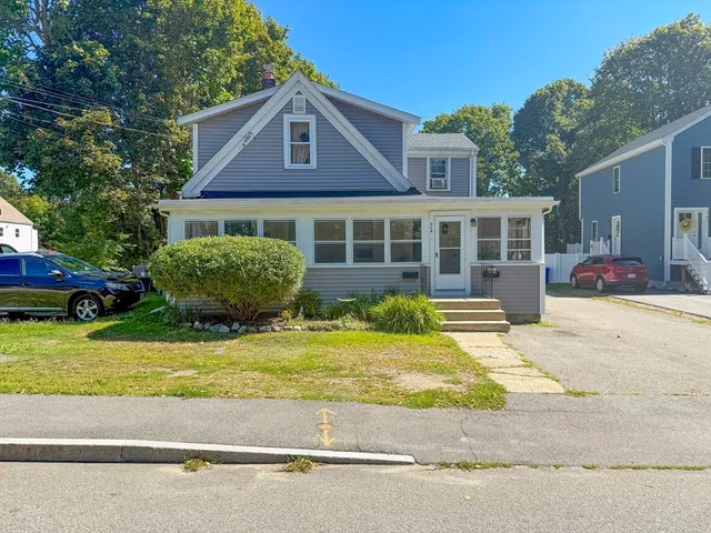 a front view of a house with a garden and plants