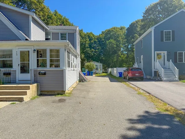 a view of a house with a yard and garage