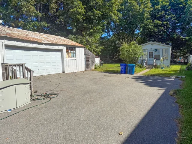a view of a house with pool and chairs