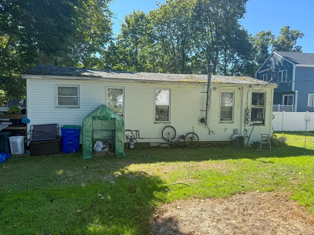 a view of a backyard with a small cabin and a chair