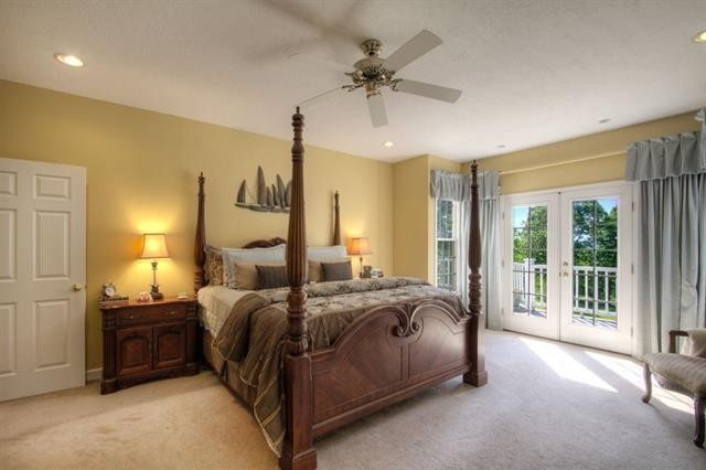 868 Reed Road Ten Mile, TN 37880 - Photo 15 of 40 a bedroom with a bed a ceiling fan and a large window